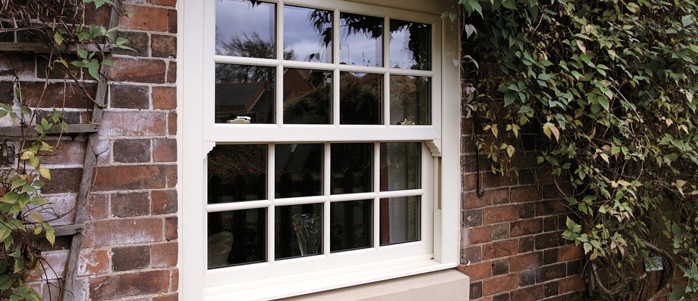 White sliding sash windows from a brick house in Shooters Hill.
